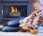 woman reading by fire